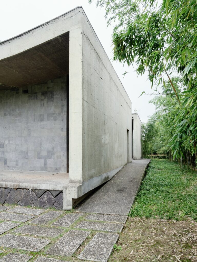 A concrete structure sitting on top of a lush green field